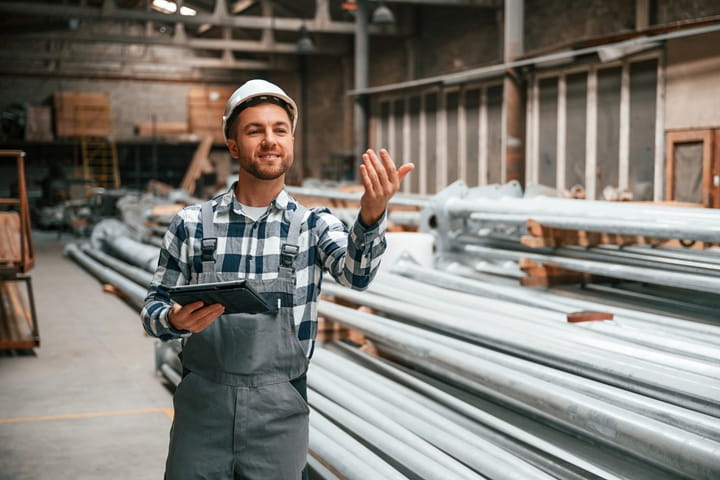 ondernemer in een hal met metalen palen